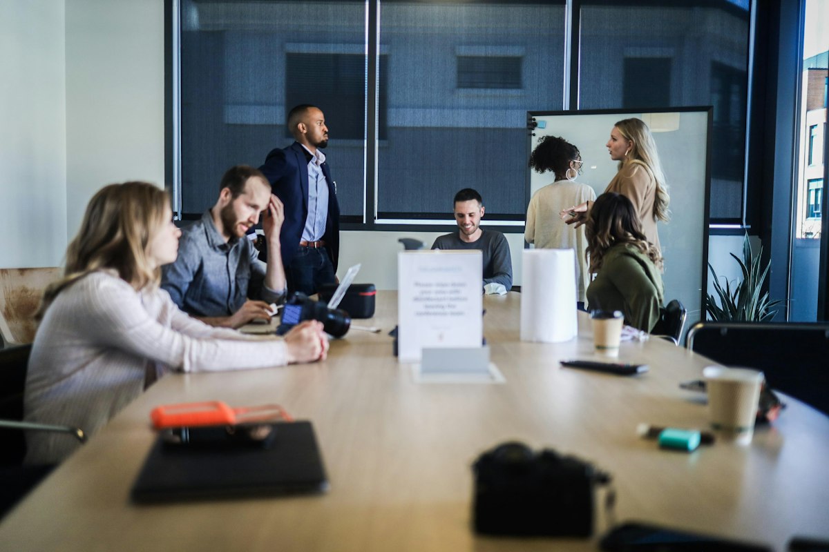 A warm working conversation over financial reports at a meeting table